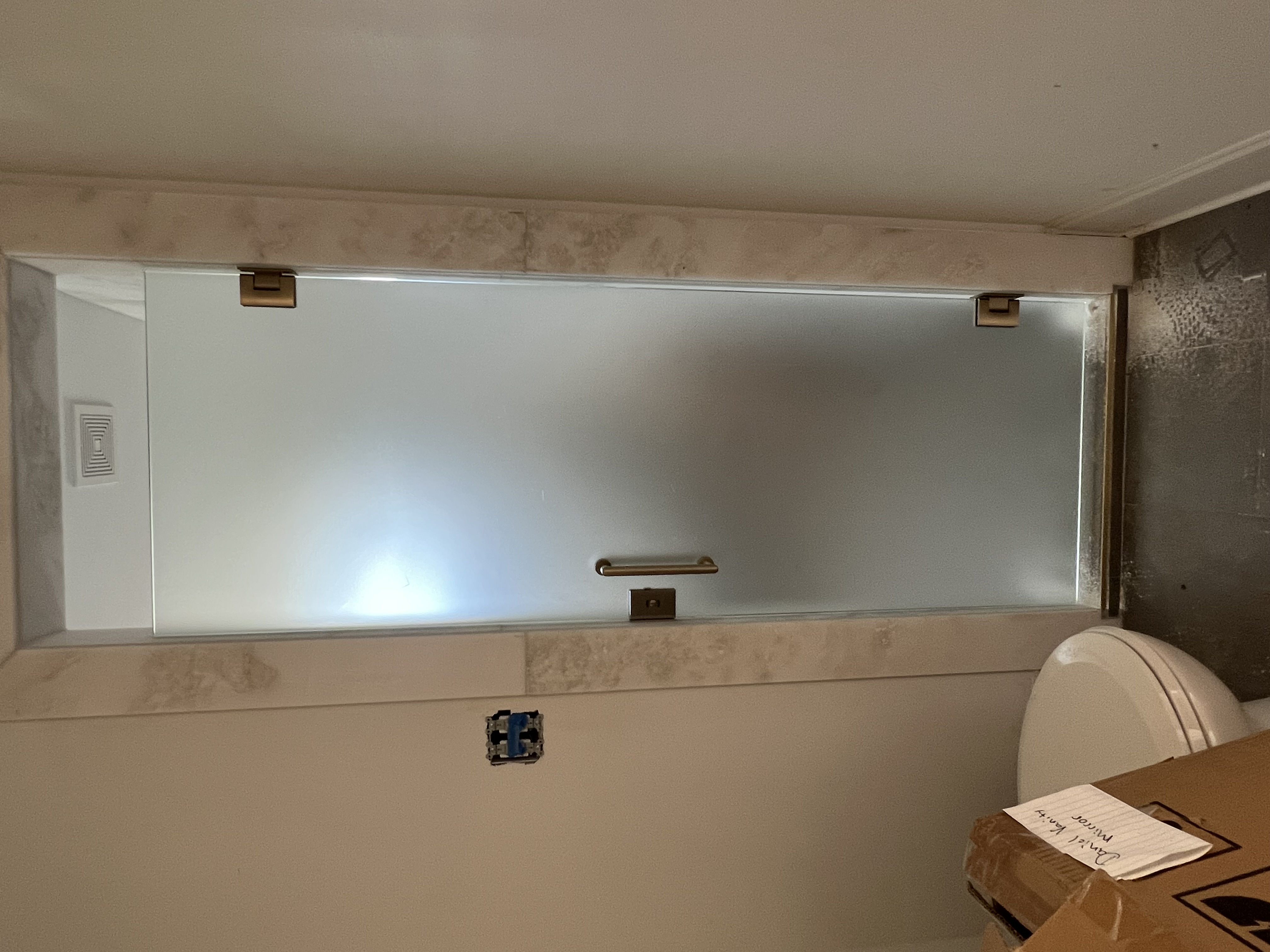 This is a custom shared shower enclosure with a lock for user privacy.