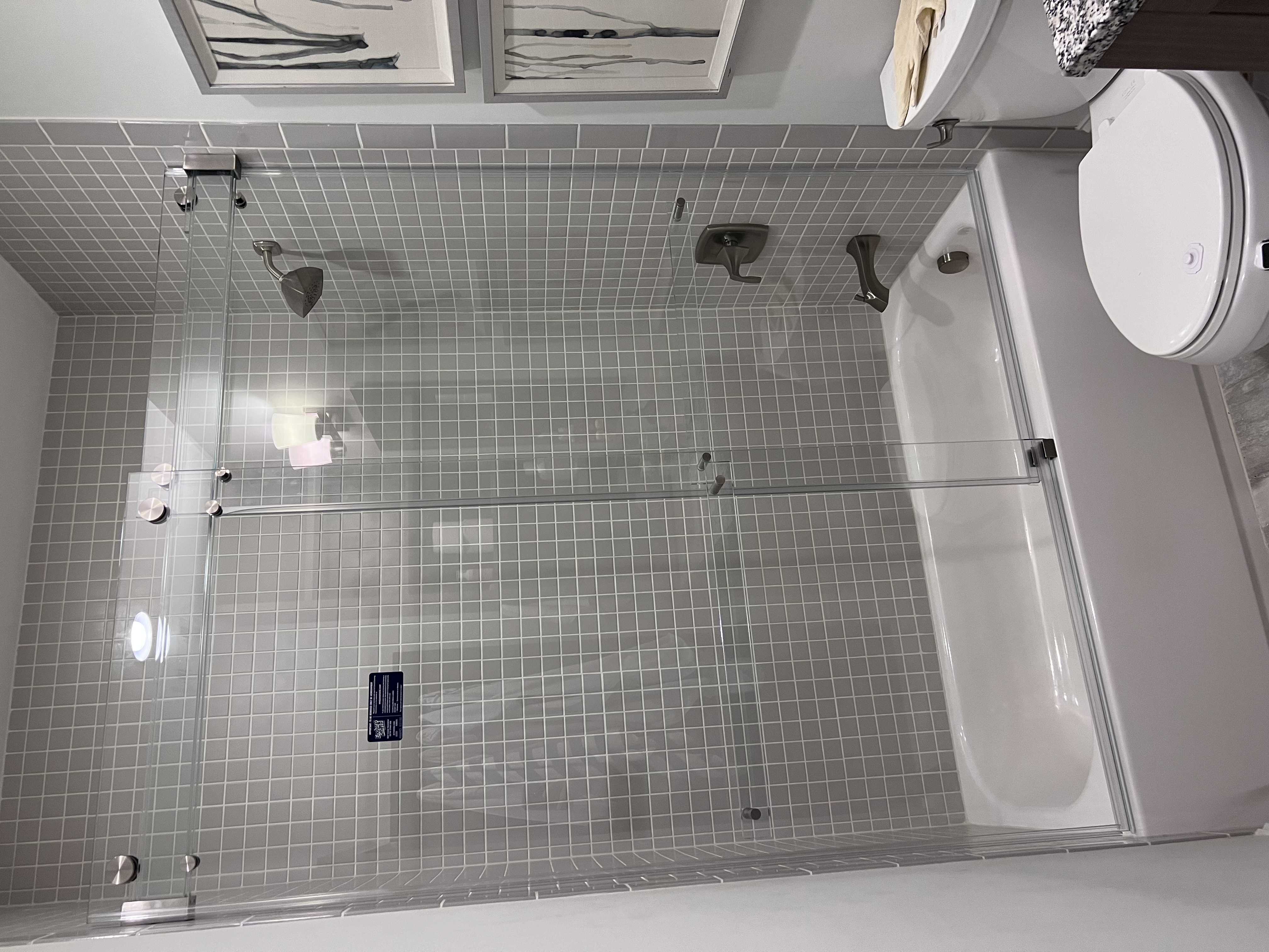 This Phantom slider from 310 Tempering includes a triple laminated low iron glass bar for maximum strength, framelessness, and functionality! This is a top-of-the-line bypassing slider system that we highly recommend for the most seamless look. This slider even includes GLASS towel bars!