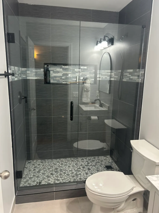 This is a matte black door and panel which elevates the look of the entire bathroom and shows off the gorgeous tile!