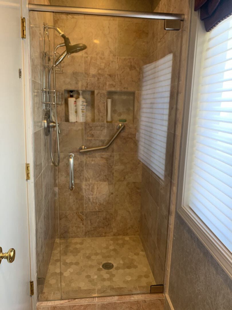 Both walls were out of plumb by approximately 1” or more requiring a header solution to maintain a plum pivot point for the door.