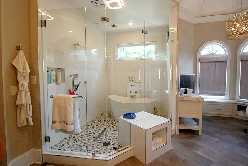 This shower enclosure is particularly special as we cut the glass to incorporate the square bench/cubby.
