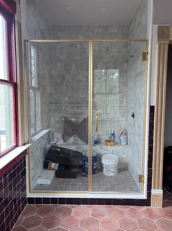 This shower door is wrapped is satin brass channel for a sleek, modern look! We love it!