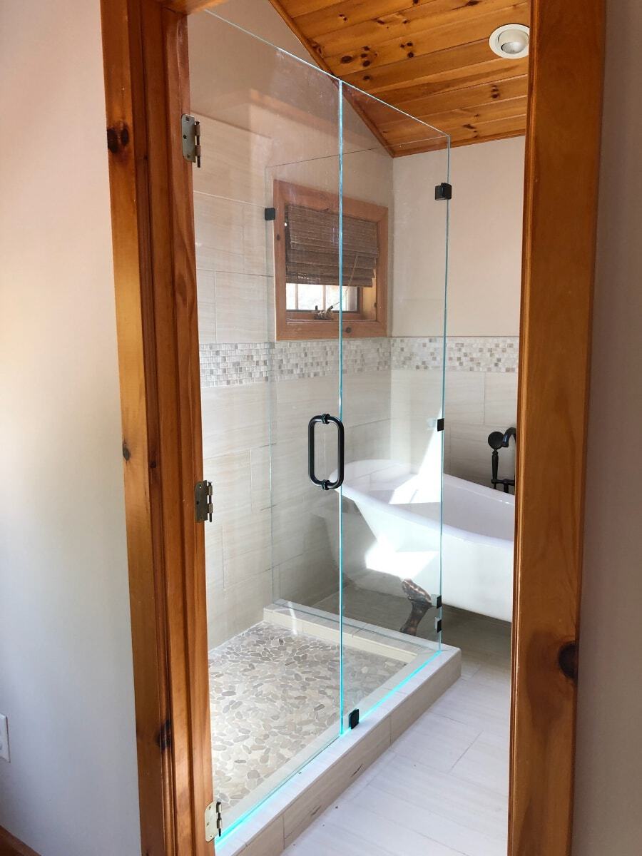 Glowing Edges. Opti White (ultra clear glass or low iron) shower glass. Unique Glowing effect edges due to white tiles and sky light above.