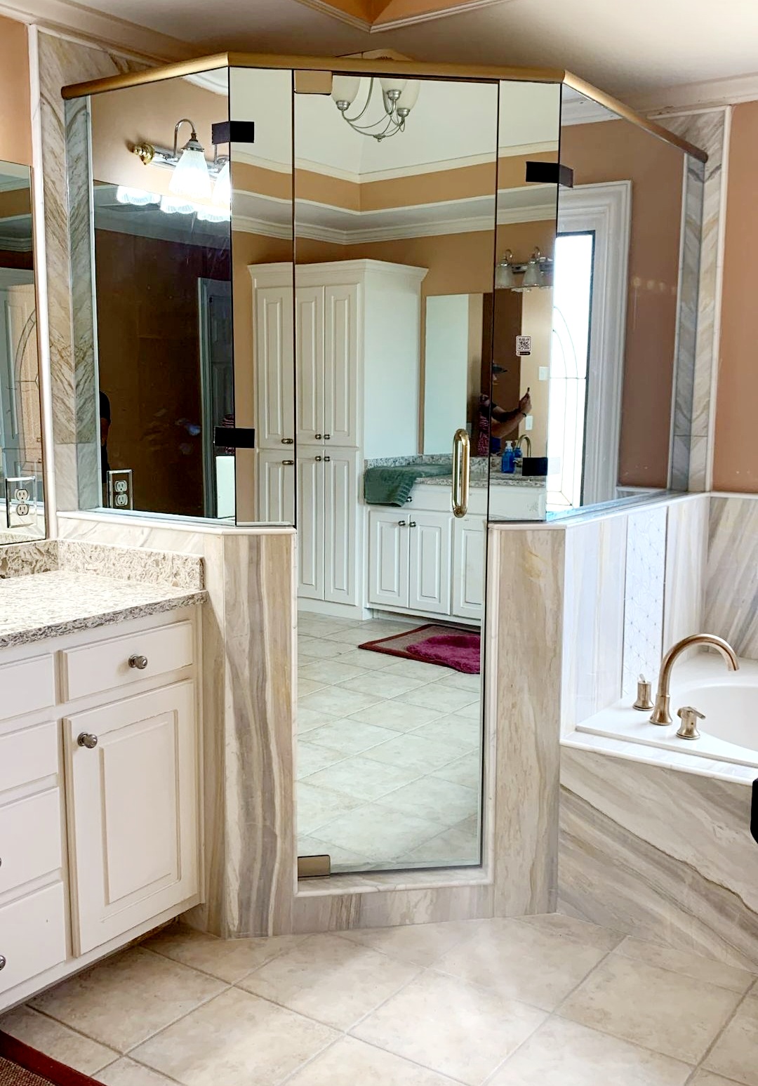 This is such a cool shower! This privacy glass allows the shower user to see out of the shower, but no one can see into the shower. The glass is called Mirror Pane and it is 1/4" tempered glass. This is Brushed Bronze hardware which matches Delta's Champagne Bronze fixtures!