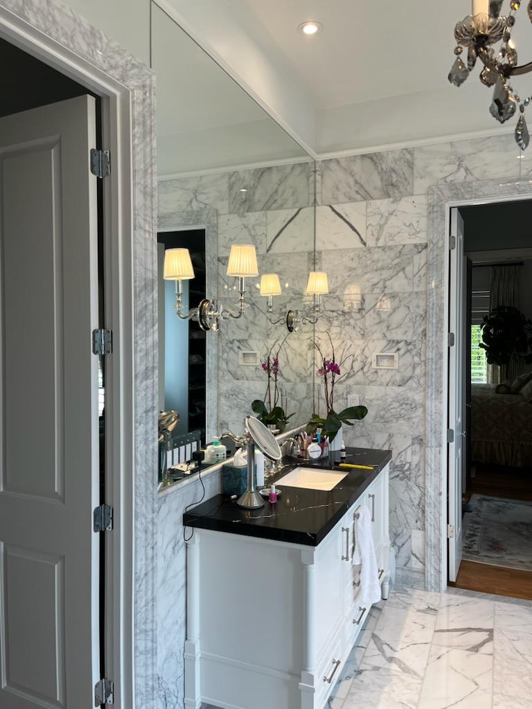 This vanity mirror has two sconces mounted into it. Ask us about custom mirrors for your bathroom or gym!