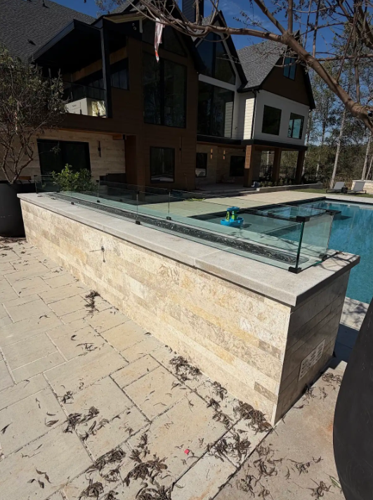We love a wind screen for your outdoor fire pit! Windscreen glass is becoming very popular, and it's an effective way to have frameless, functional elegance.