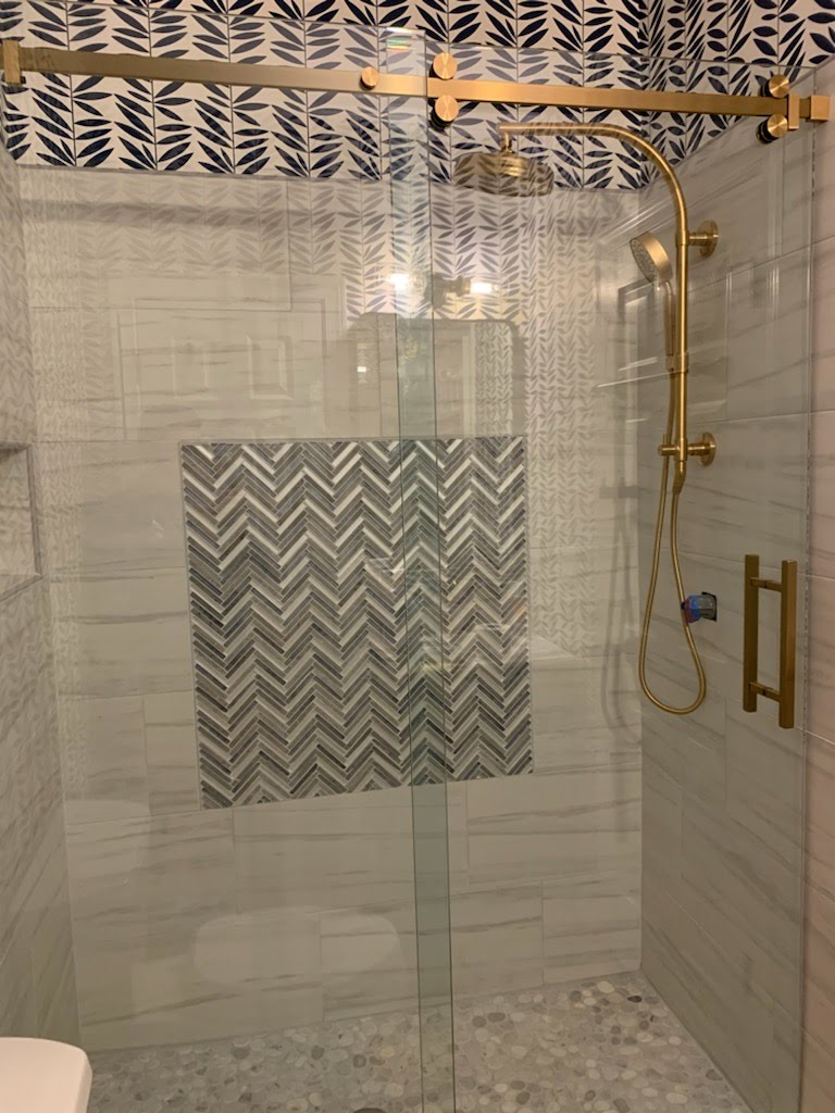 This gorgeous sliding system incorporates the look of the barn style slider with the trending brushed gold color hardware finishes.